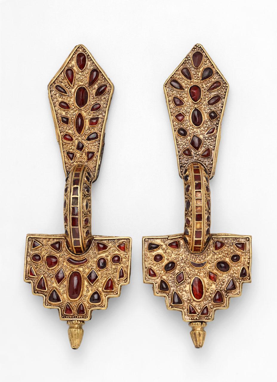 SILVER FIBULA COVERED WITH SHEET GOLD, WITH GARNETS.