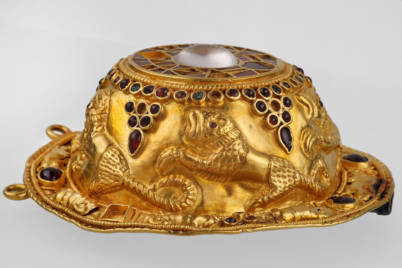 Gold disc fibula decorated with cloisonné and embossed animal figures.